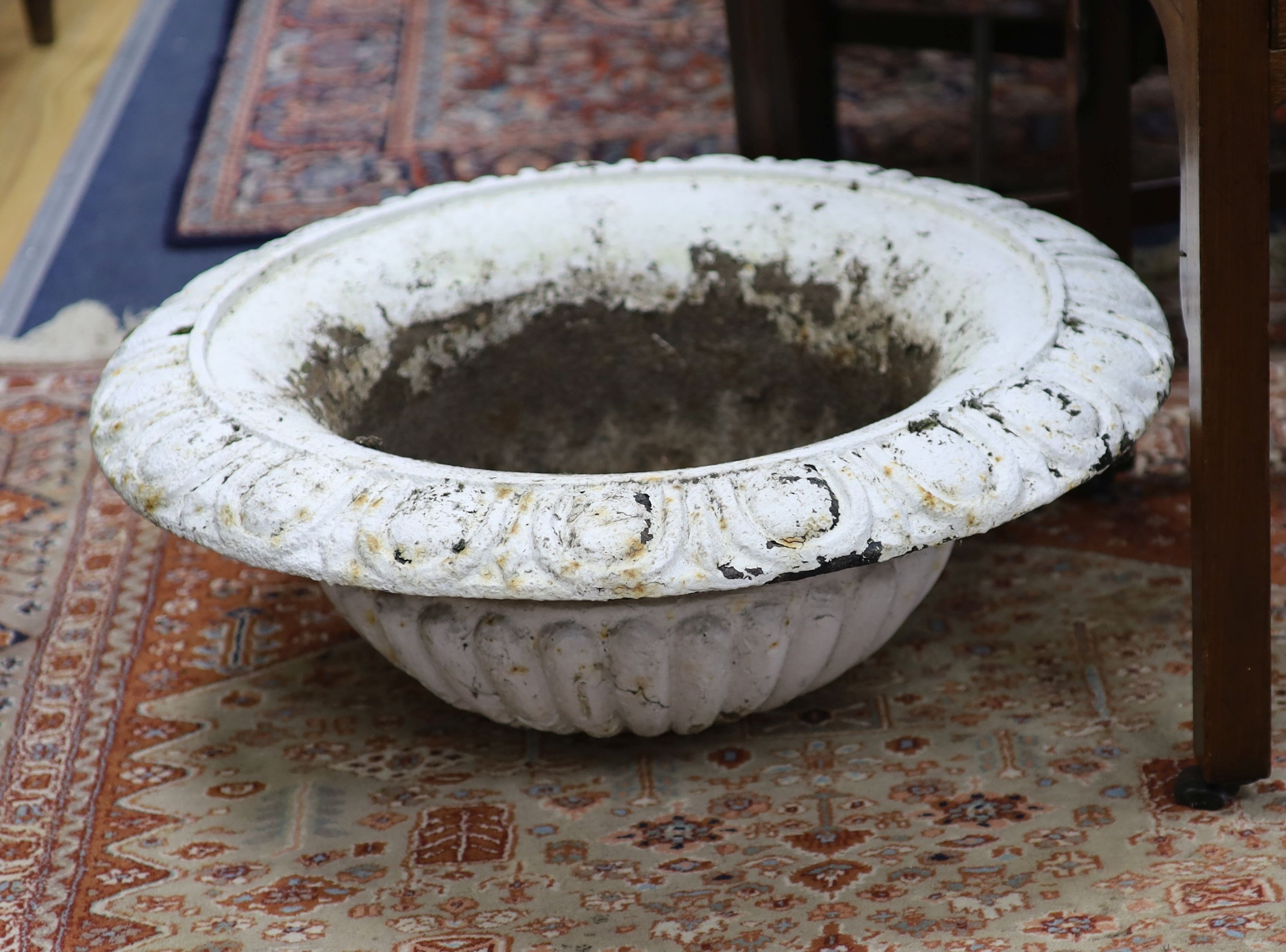 A pair of Victorian cast iron garden urns, one lacking base, 60.5 cm diameter